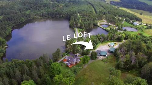 an aerial view of a house on a lake at Domaine Gagnon in Saint Sebastien