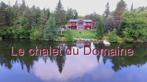 an aerial view of a house on a lake at Domaine Gagnon in Saint Sebastien