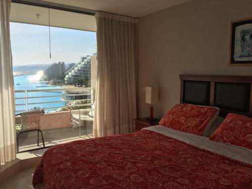 Una cama o camas en una habitación de Arriendo San Alfonso del Mar