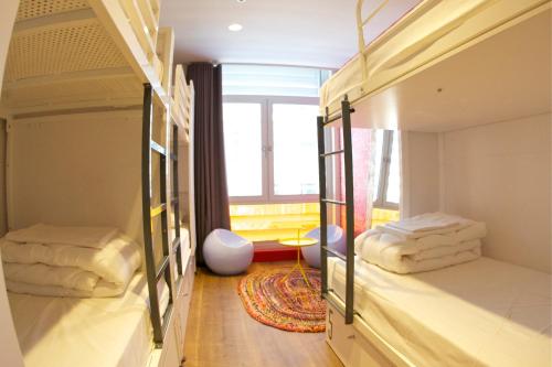 two bunk beds in a room with a window at Generator Barcelona in Barcelona