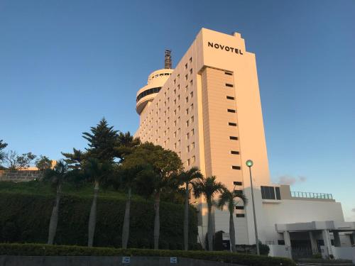 a building with the word novation on the side of it at Novotel Okinawa Naha in Naha