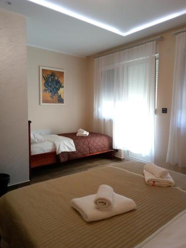 a bedroom with a bed and two towels on the floor at Konak Kutko in Pančevo