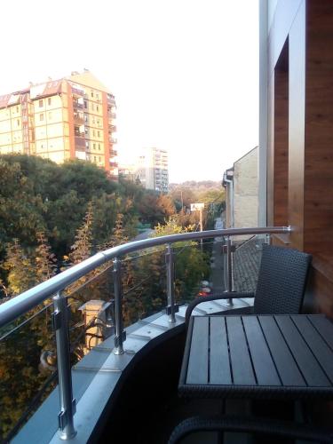 a balcony with a wooden bench on a building at Konak Kutko in Pančevo