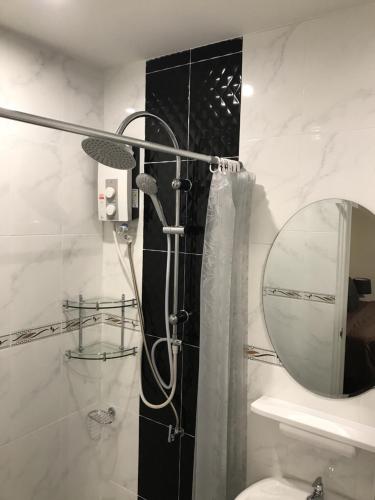 a bathroom with a shower and a mirror at Buncha Place in Bang Tao Beach