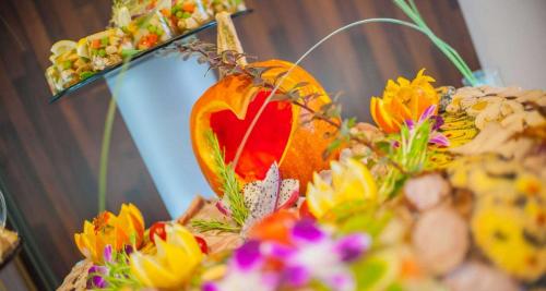 a display of flowers and a heart shaped fruit at Premier Kraków Hotel in Kraków