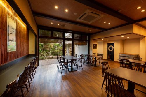 a restaurant with tables and chairs in a room at Arima Onsen Koki in Kobe