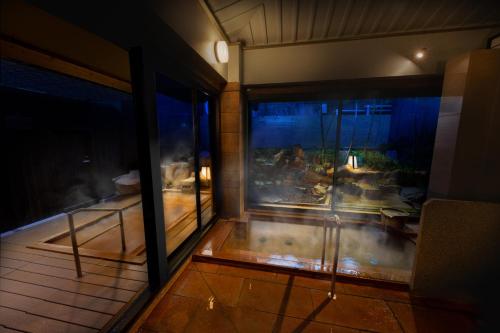 a room with a large aquarium in a building at Arima Onsen Koki in Kobe