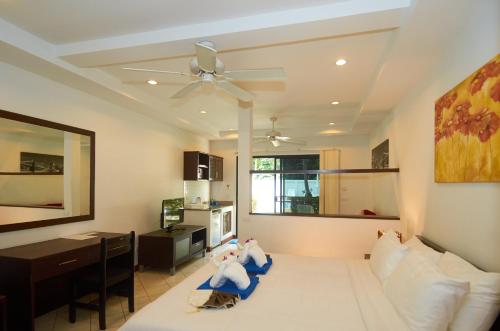 a living room with a couch and a ceiling fan at Phuket Riviera Villas Hotel in Nai Harn Beach