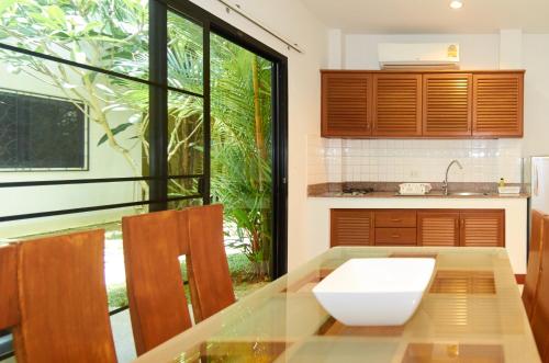 a kitchen with a table with a white bowl on it at Phuket Riviera Villas Hotel in Nai Harn Beach