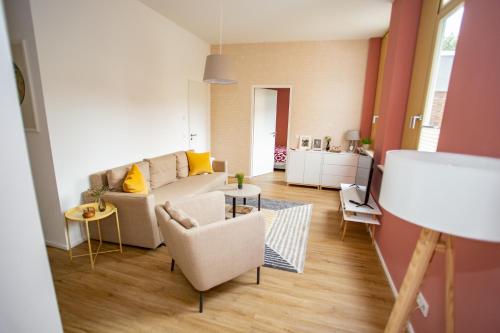 a living room with a couch and a table at Eckhof Domizil in Gotha