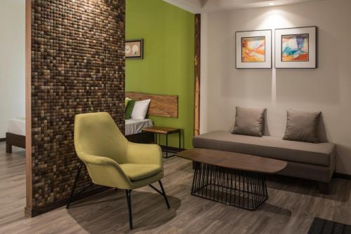 a living room with a couch and a chair at Casa Florida Hotel & Spa in Pereybere