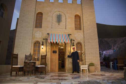 a priest standing in front of a church at Taba Sands Hotel & Casino in Taba