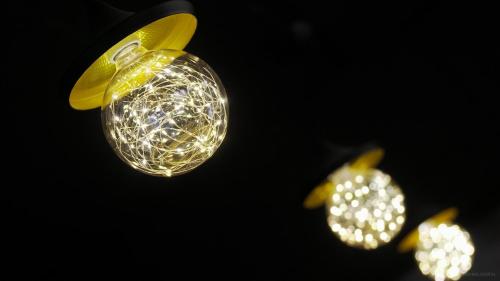 a group of lights hanging from a ceiling at One Way Guesthouse Busan in Busan