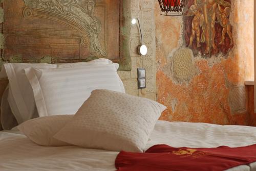 a bedroom with a white bed with a wall at Diplomat Plaza Hotel & Resort in Lukovit