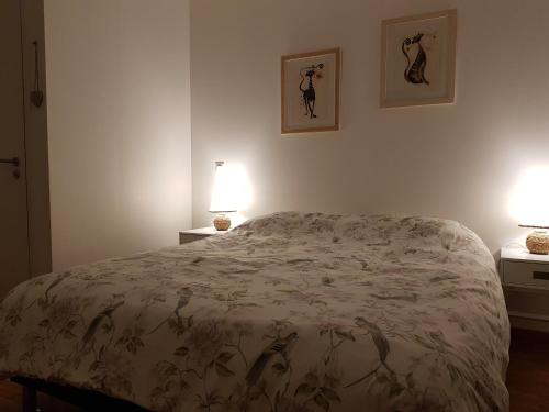 a bedroom with a bed and two lamps on two tables at Le Domaine des Prés in Lachambre