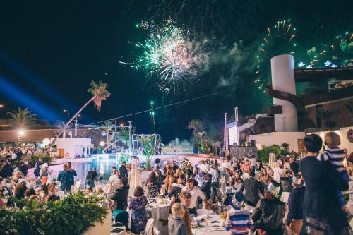 a crowd of people at a party at night with fireworks at Hard Rock Hotel Tenerife in Adeje