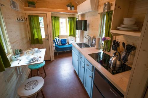 a kitchen with a sink and a counter top at Mount Hood Village Zoe Tiny House 9 in Welches