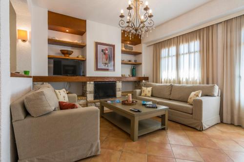 a living room with two couches and a table at Elaia Villas in Pythagoreio
