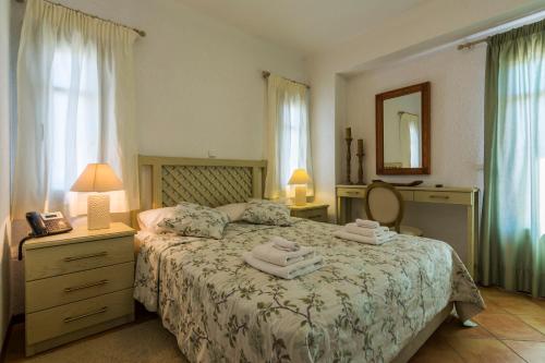 a bedroom with a bed with towels on it at Elaia Villas in Pythagoreio