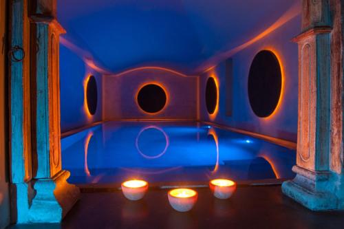 a group of candles in a room with blue lights at Hotel Federico II Central Palace in Palermo