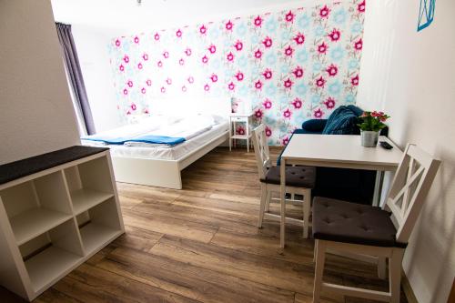 a small room with a bed and a table at Landgasthof Hotel Will in Neuenstein