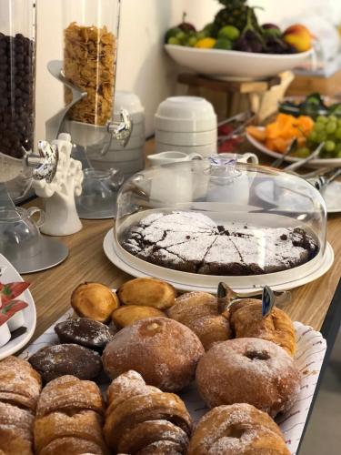 a table with a bunch of donuts on a table at Il Giardino Della Regina in Gallipoli