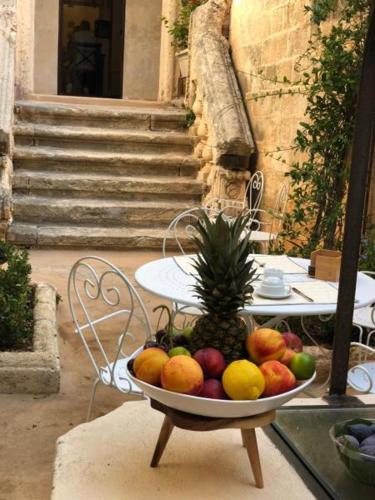 a bowl of fruit sitting on a table at Il Giardino Della Regina in Gallipoli