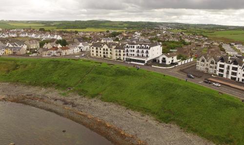 an aerial view of a town with houses and a street at Bayview Hotel in Bushmills