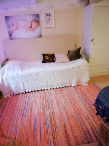 a bedroom with two beds and a large rug at Mökki Kujala in Nummi