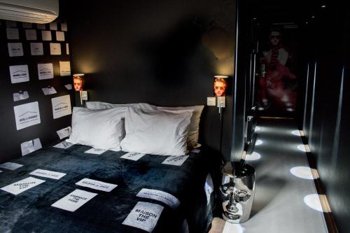 a bedroom with a bed with labels on it at Hotel The Exchange in Amsterdam