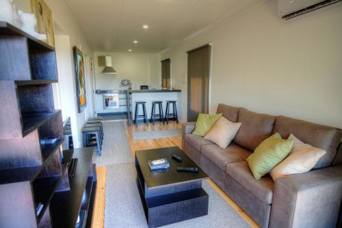 a living room with a couch and a table at Quinta de Silharezes, Lda in Ponte da Barca