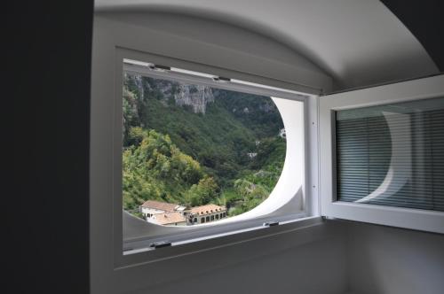 a window with a view of a mountain at Via Paradiso in Amalfi