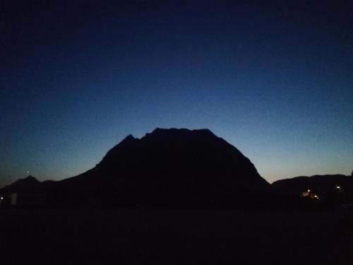 a silhouette of a mountain against a blue sky at Amtmannhaus Ferienunterkunft in Irdning