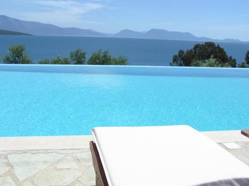 a swimming pool with a view of the water at La Casa Di Nonna Anna in Nikiana