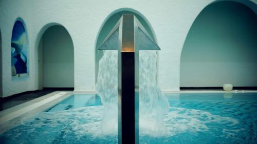 a pool of water with a cross in the water at Aegialis Hotel & Spa in Aegiali