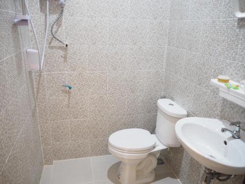 a bathroom with a toilet and a sink at Villa Phonethavy in Luang Prabang