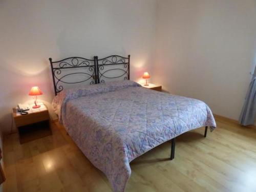 a bedroom with a bed and two tables with lamps at " Il Bersagliere " Dependance Hotel la Pace in Asciano