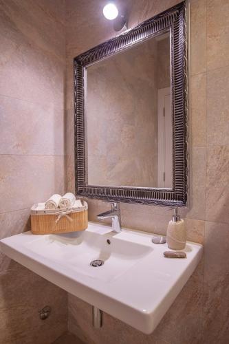 a bathroom with a sink and a mirror at Aria Apartments in Kotor