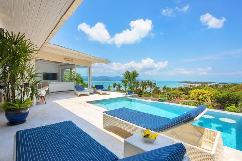 a villa with a swimming pool and a view of the ocean at Samui Bayside Luxury Villas in Choeng Mon Beach