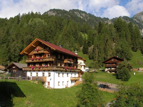 a house on a hill with flowers on it at Gästehaus Dorer Gerhard in Prägraten am Großvenediger