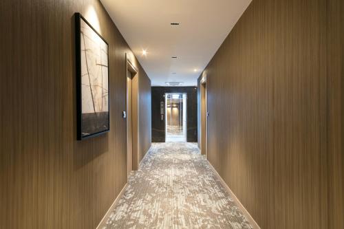 a hallway with wood paneled walls and a long corridor at Hotel AMI Budva Petrovac in Petrovac na Moru