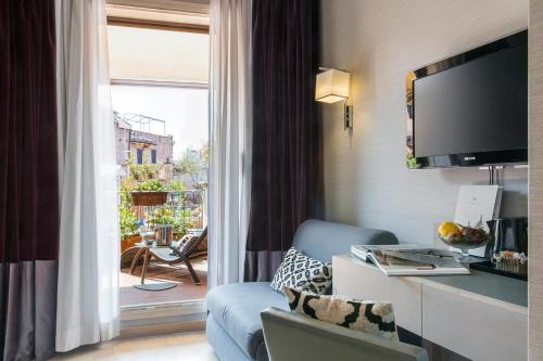 a hotel room with a television and a window at Hotel Adriano in Rome