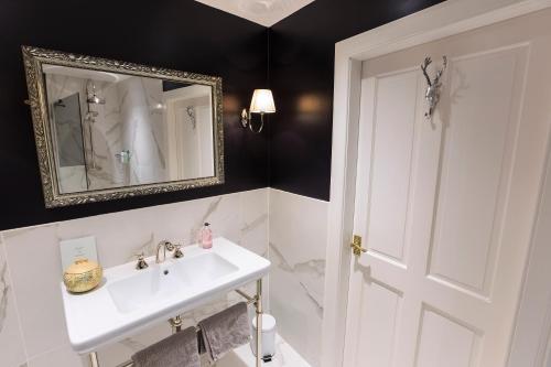 a bathroom with a sink and a mirror at The Studio at Maspie House in Falkland