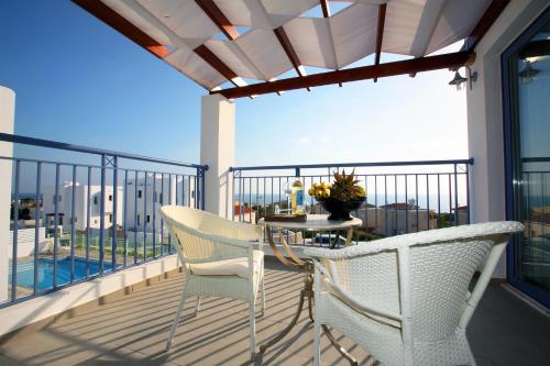 a balcony with a table and chairs on a balcony at Meltemi Villas in Paphos City