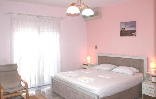 a bedroom with a bed and a chair and a window at Villa Center in Tirana