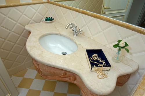 a sink in a bathroom with a book on it at Villa Signori in Marina di Pietrasanta