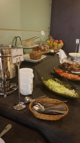 a table with a bunch of food on it at Hotel Libertador in Santiago