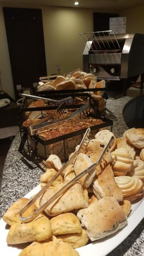 a plate of food on a table with bread at Hotel Libertador in Santiago