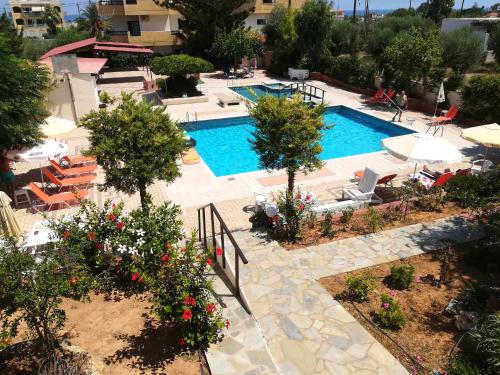 an overhead view of a swimming pool with chairs and flowers at Marigianna in Gouves