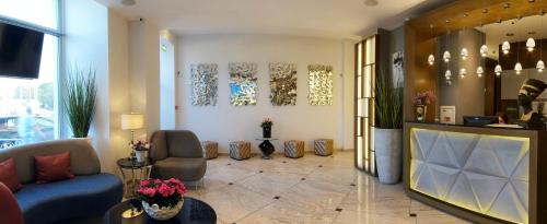 a lobby with a blue couch and chairs in a building at 3 City Hostel in Gdańsk